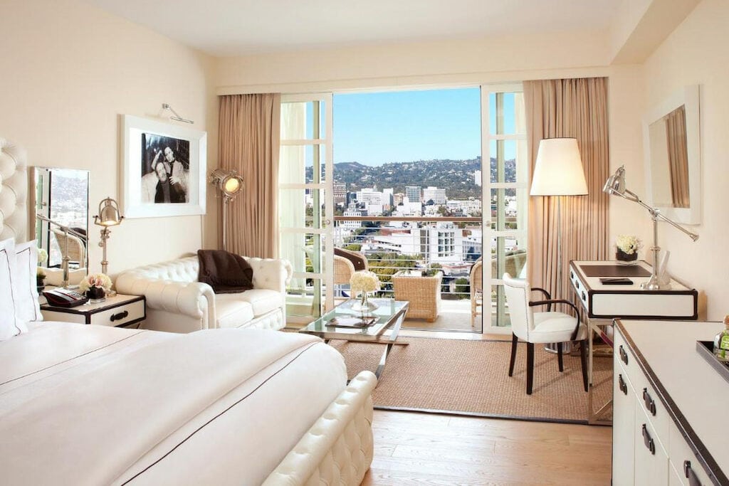 white furniture in best boutique hotel in Beverly Hills with open balcony door and views