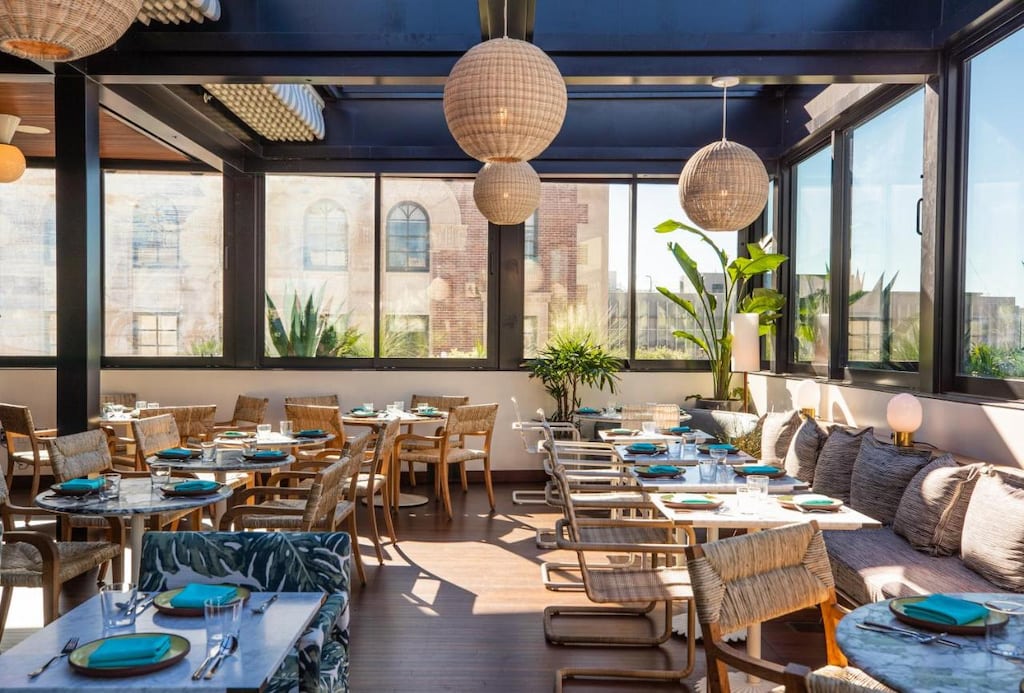 rooftop dining with large round chandeliers at the coolest hotels in Los Angeles Downtown