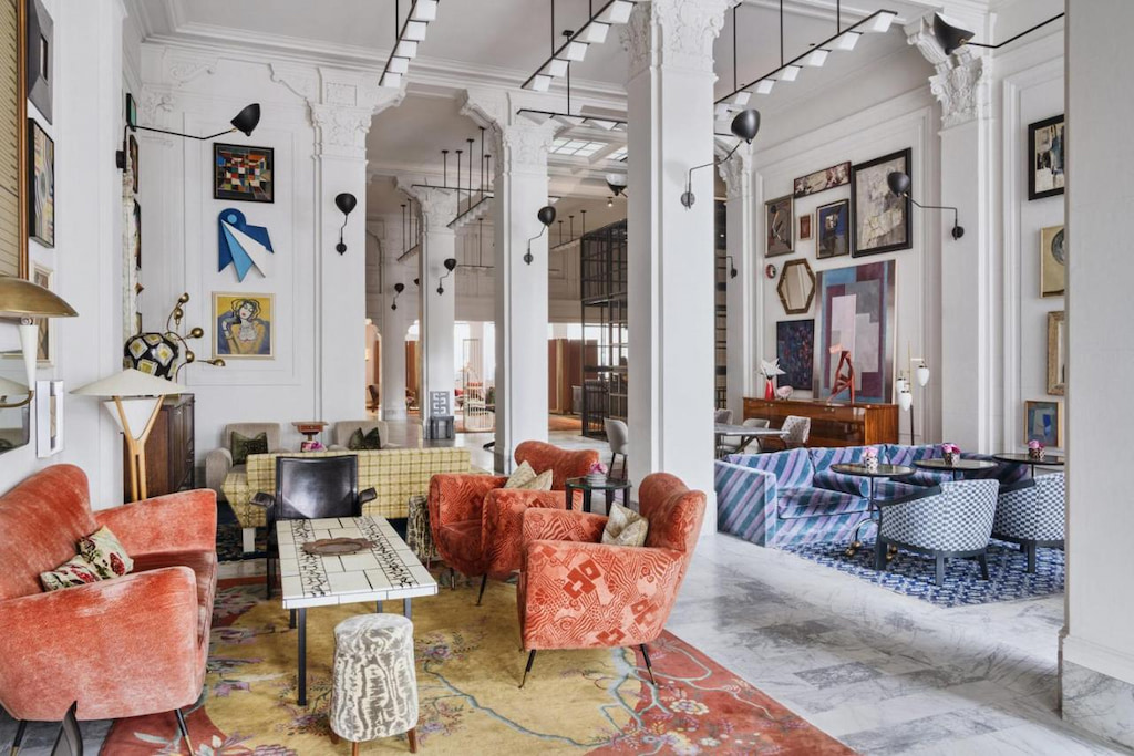 boutique hotel meaning eclectic decor and artwork in a large hotel lobby with white pillars