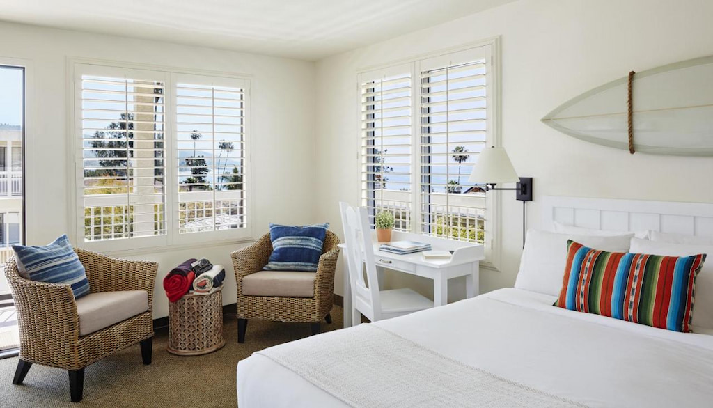 cool Laguna Beach boutique hotel room with rattan chairs beside the window