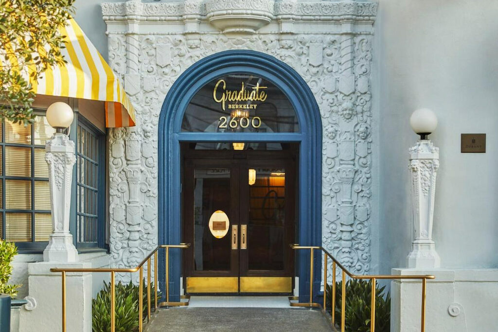 The entrance of one of the hotels Berkeley CA with a blue arch entrance at the door
