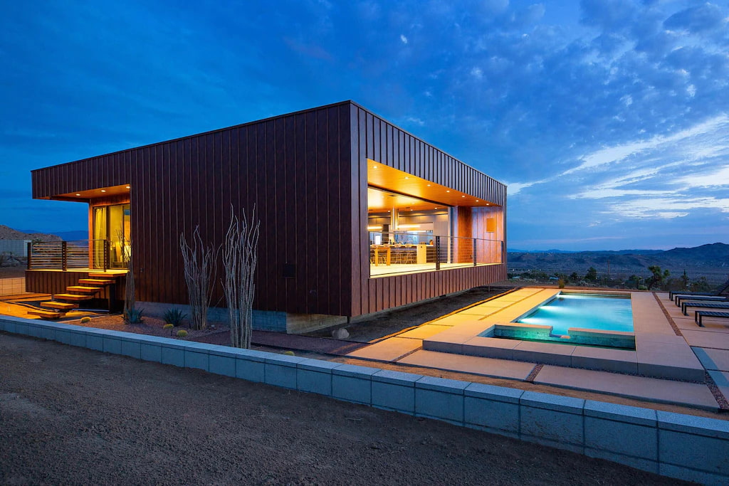 modern box style property and its outdoor pool at night in a hotel near Joshua Tree National Park