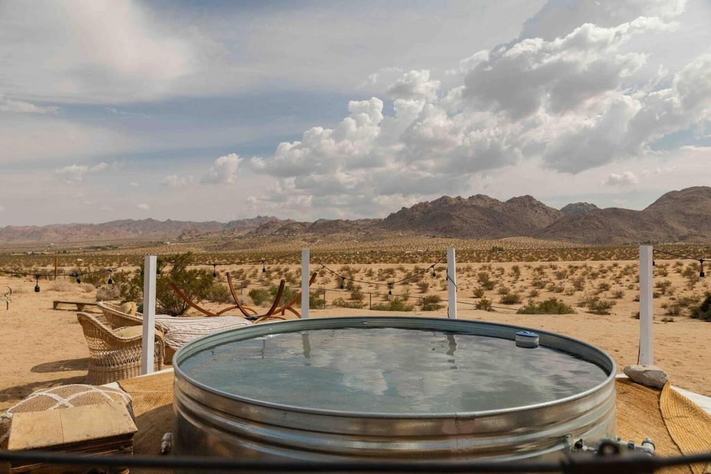 metal circular swimming pool with desert and mountain views on a cloudy day in Joshua Tree NP