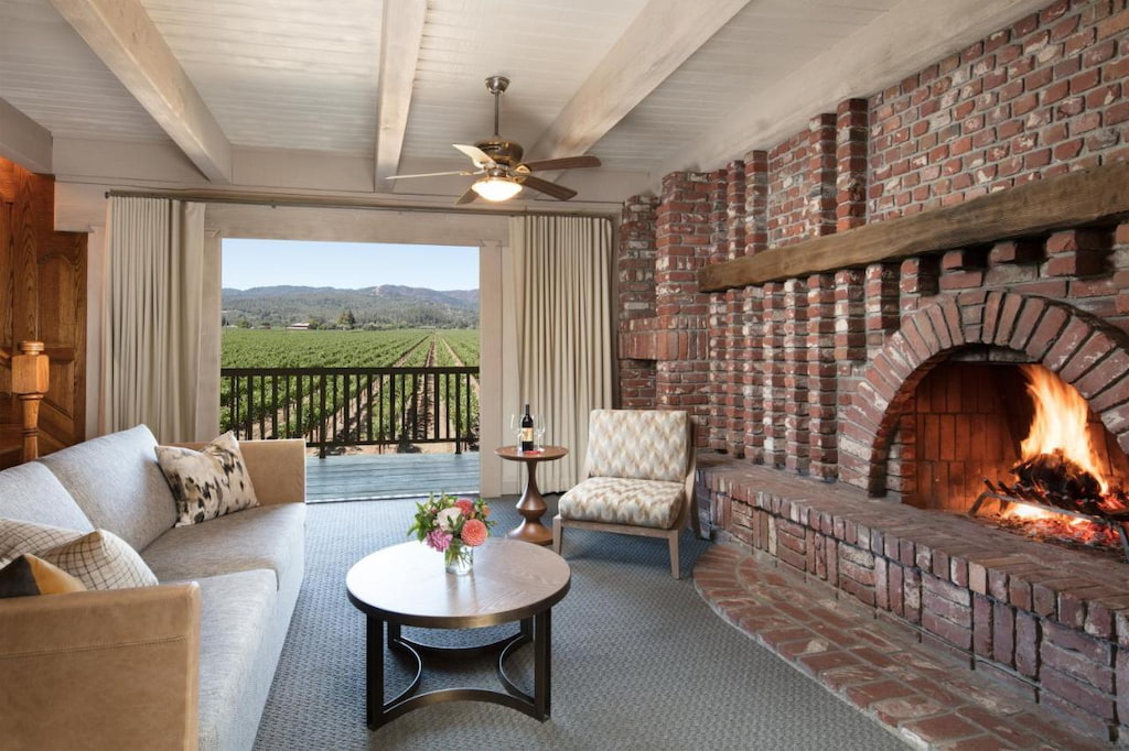 A brick-style fireplace facing the chic couches in the living room in one of the hotels in Napa.