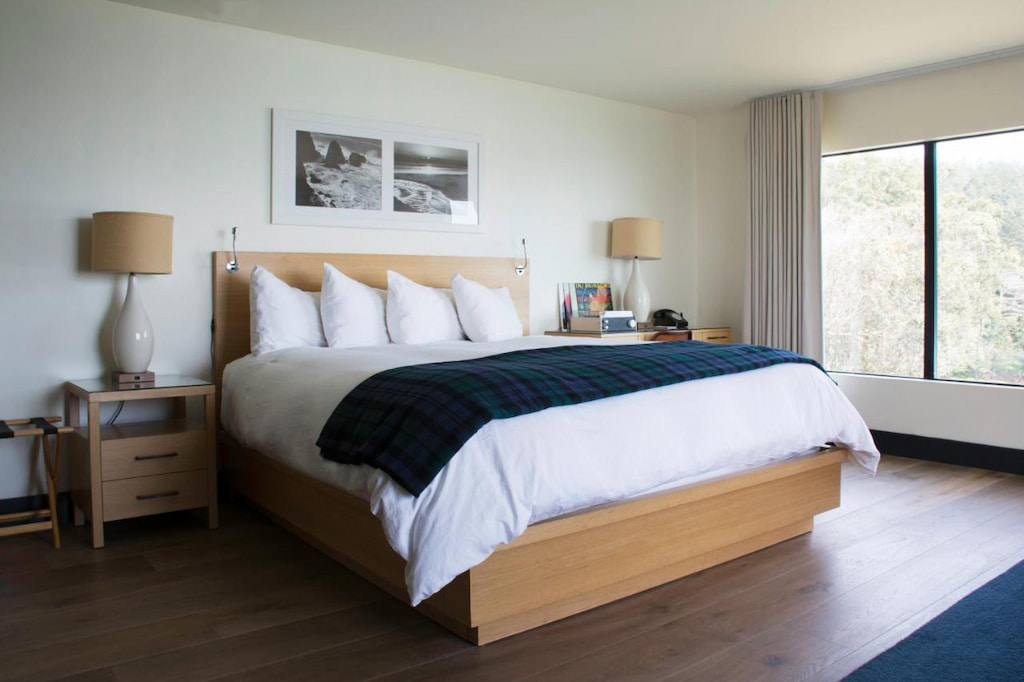 a luxury room with king size bed near the window in one of the best boutique hotels in Northern California Coast.
