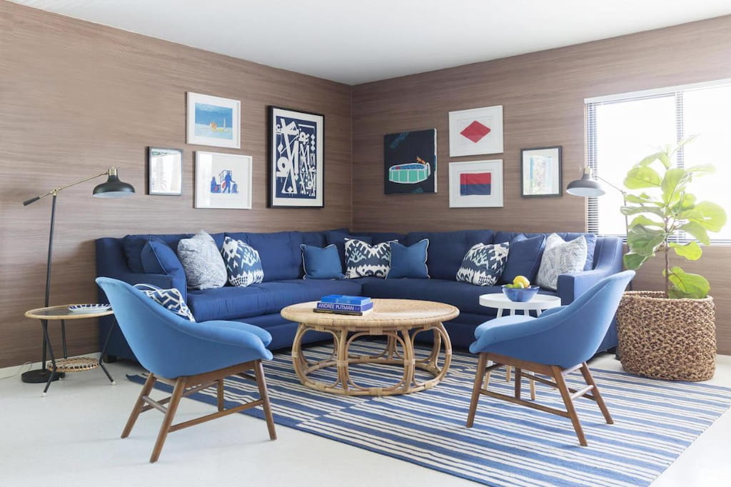 A corner living room with a blue couch set.