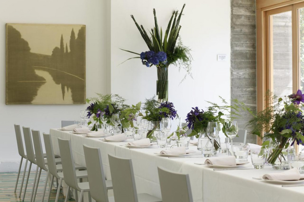 Long table with white chairs