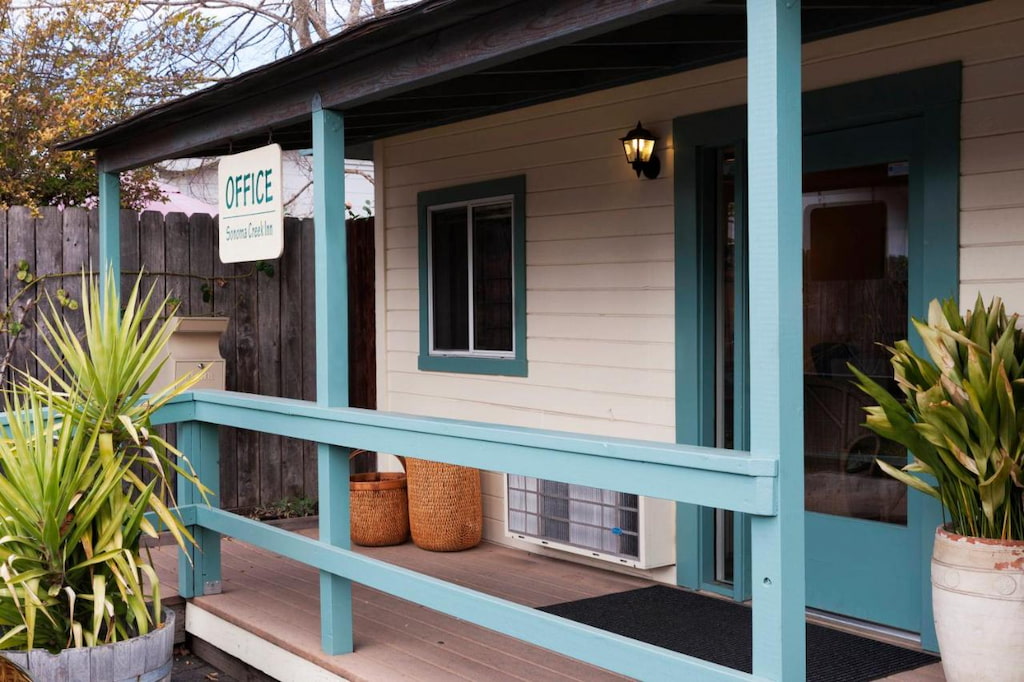 small porch at the entrance of a Sonoma hotel with bright blue banisters and door frame