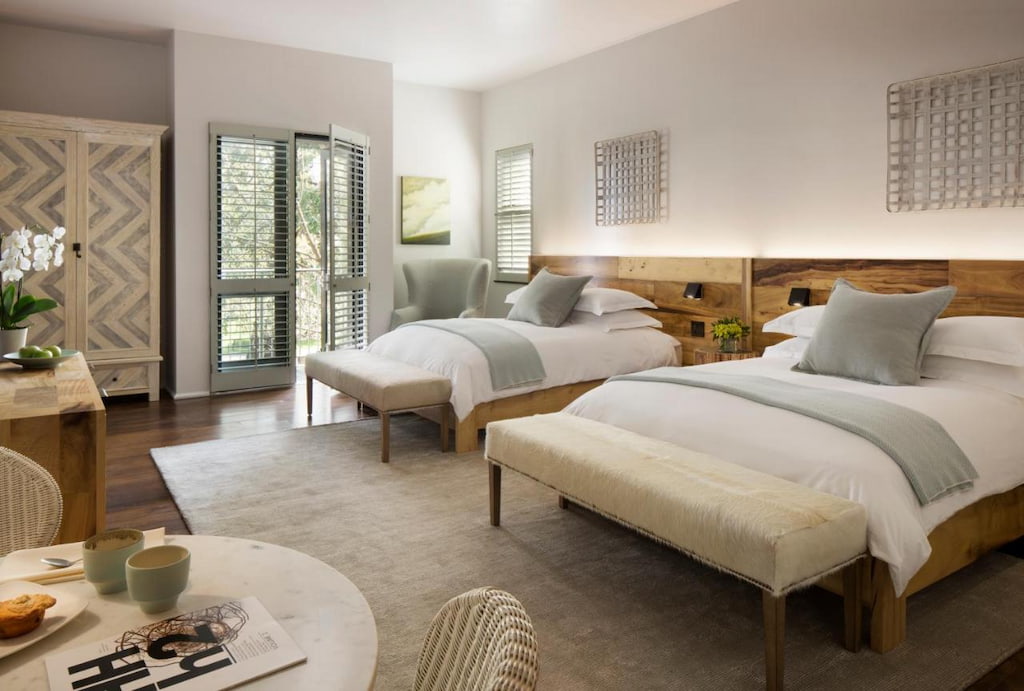 comfortable light colored decorated hotel in Sonoma with a couple of beds with white sheets