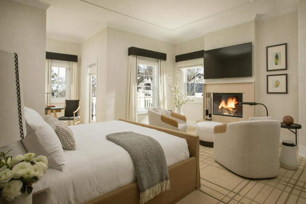 modern all white suite at a hotel in CA with fireplace and tv