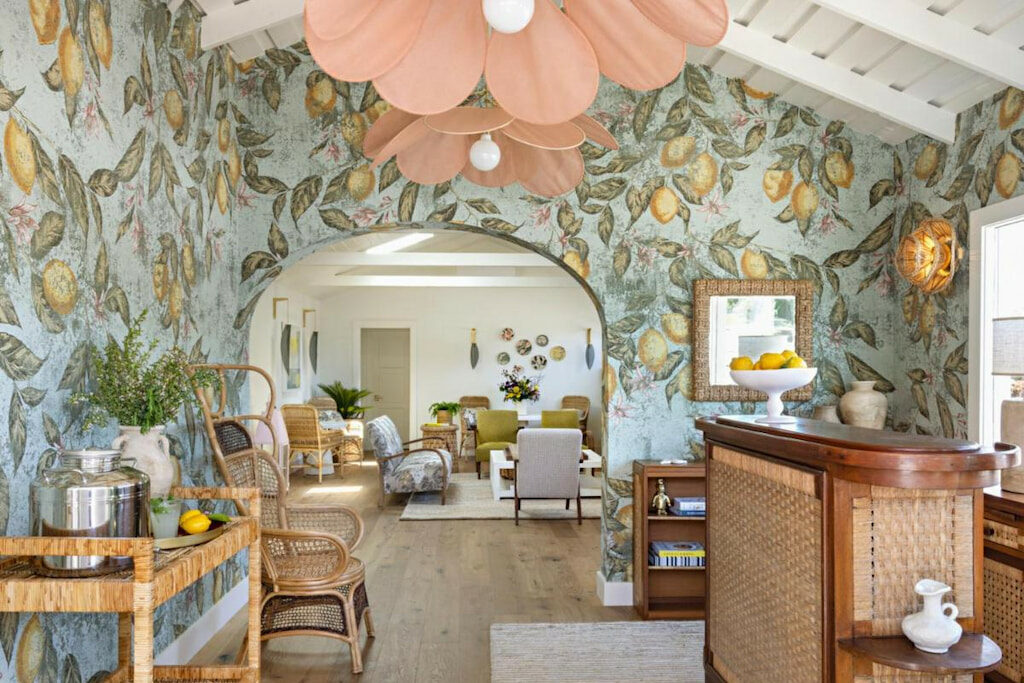 lobby of a Paso Robles boutique hotel with lemon patterned blue wallpaper, pink flower chandelier and wicker furnishings